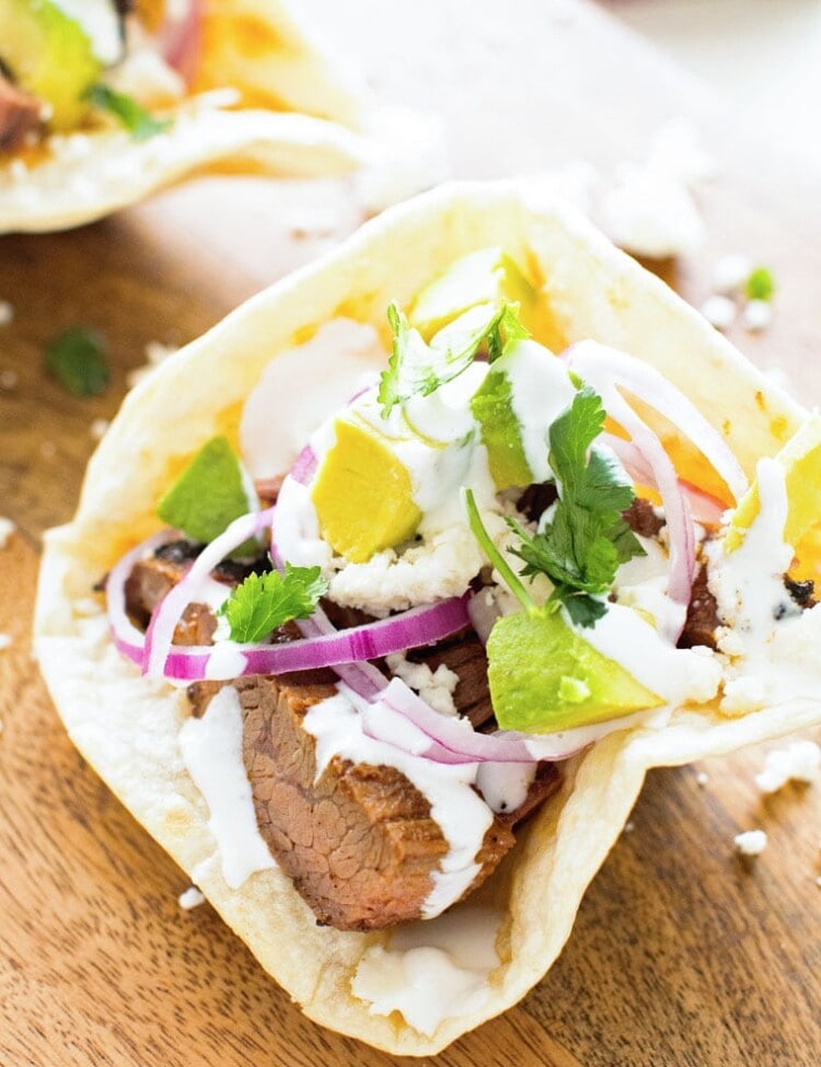 Flank Steak in homemade taco bowl on a wooden table