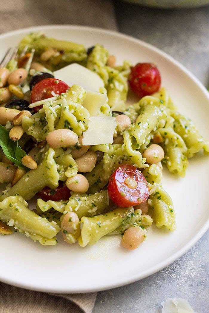 Closeup of Cold Pesto Pasta Salad on a white plate.