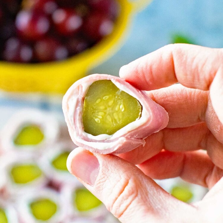 Cream Cheese Ham Pickle Roll Up Piece in hand