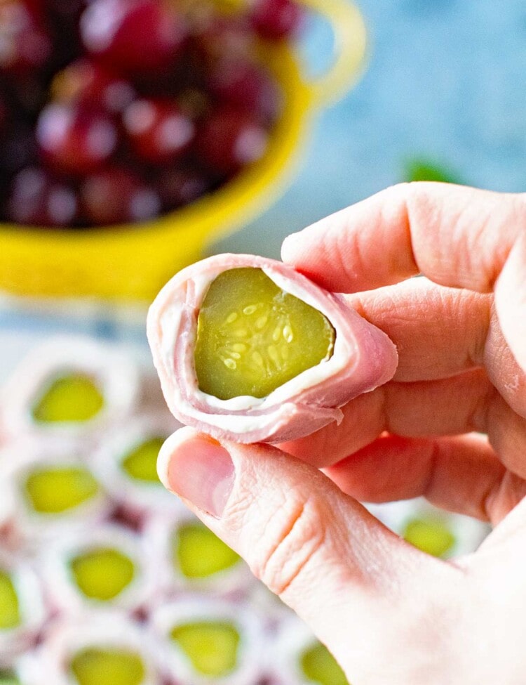 Cream Cheese Ham Pickle Roll Up Piece in hand