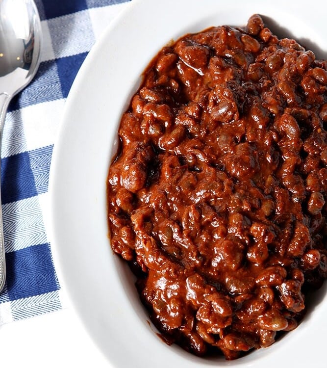 Overhead of Instant Pot Baked Beans, served in a white bowl.