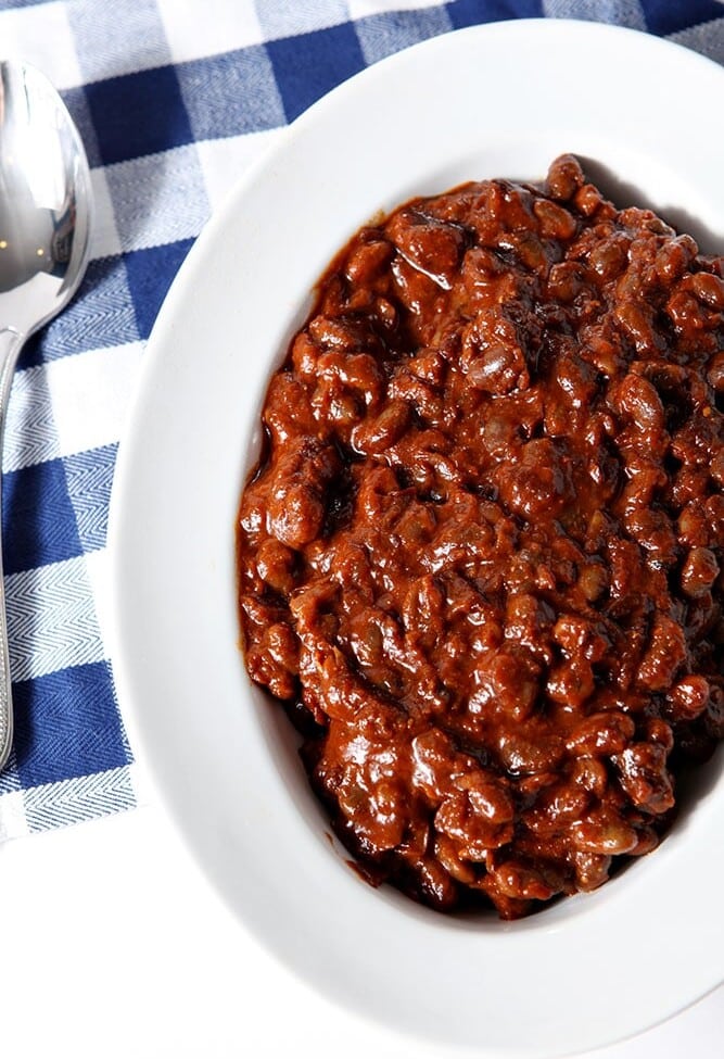 Overhead of Instant Pot Baked Beans, served in a white bowl.