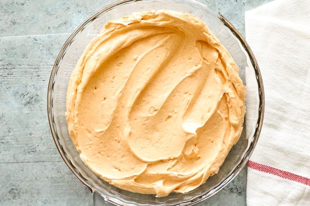 Glass pie dish with cream cheese taco layer