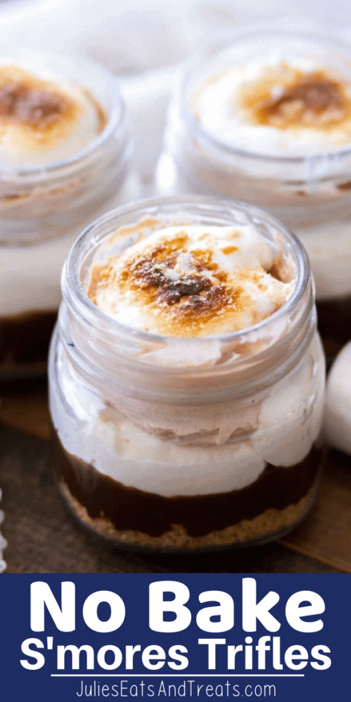 Mason jars of no bake s'mores trifles on a wood table