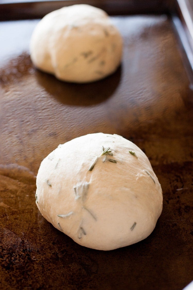 Loaf of proofed rosemary bread