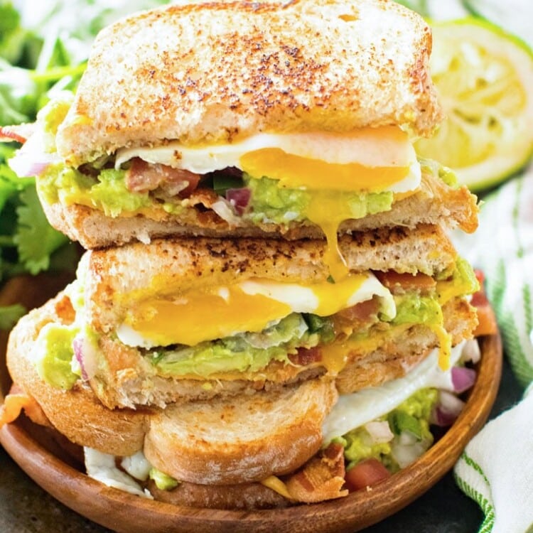 Southwestern Breakfast Sandwich Cut Open and stacked on a wood plate