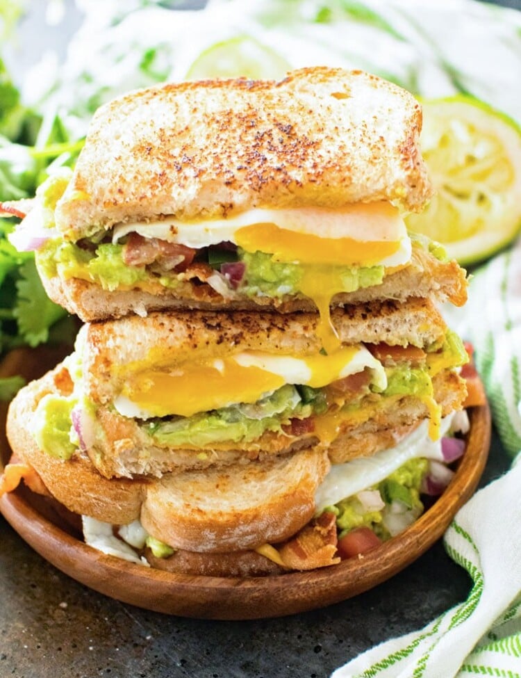 Southwestern Breakfast Sandwich Cut Open and stacked on a wood plate