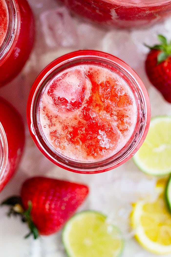 Overhead of Strawberry Lemonade Margarita in Mason Jars