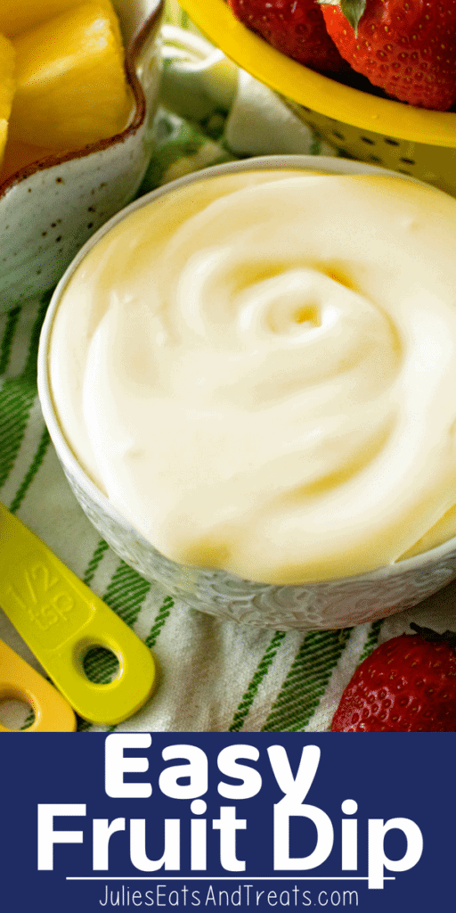 Fruit Dip in a grey bowl next to strawberries on a green and white striped towel