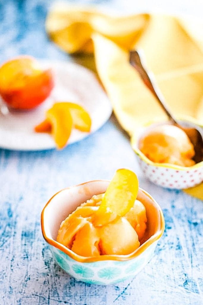 Blue background withw bowls of peach sorbet