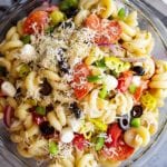 Pepperoni pasta salad in a glass mixing bowl