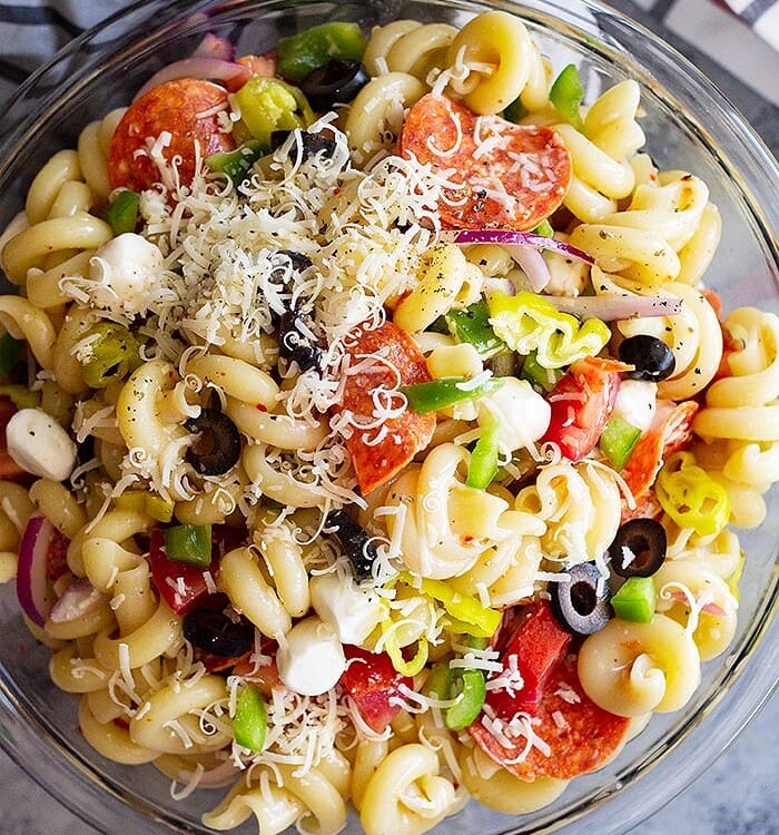 Pepperoni pasta salad in a glass mixing bowl