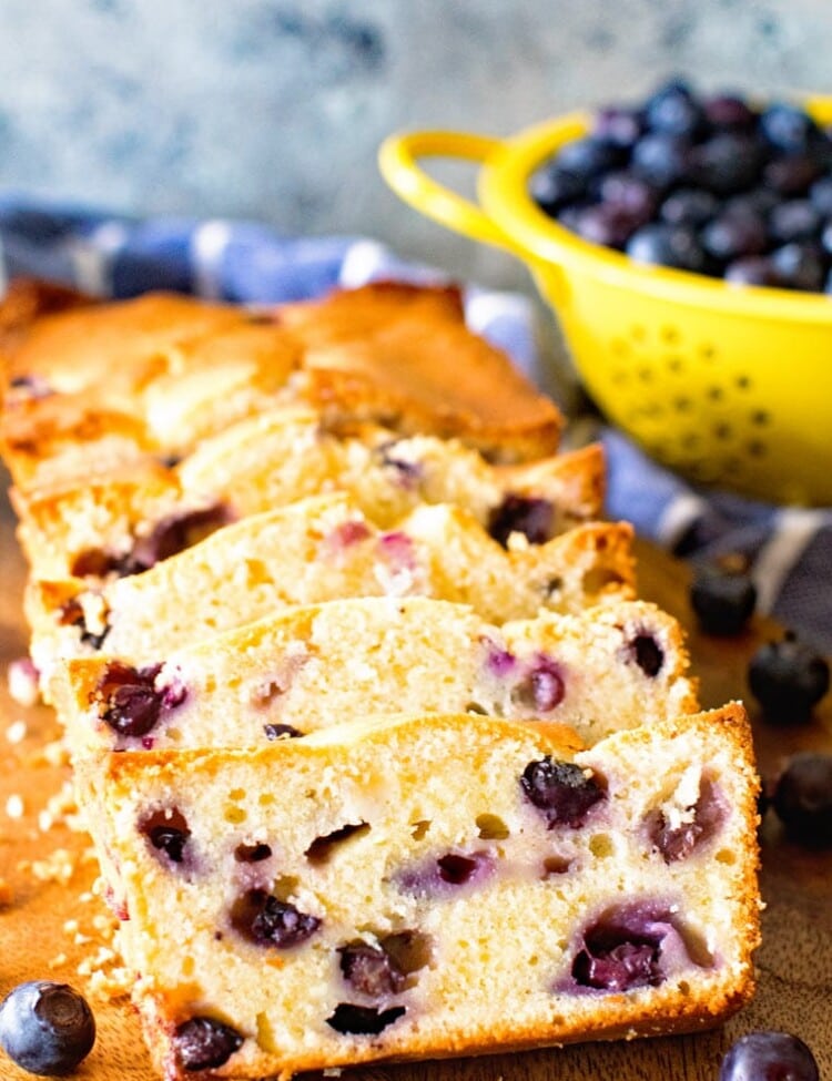 Cream Cheese blueberry bread sliced on a cutting board
