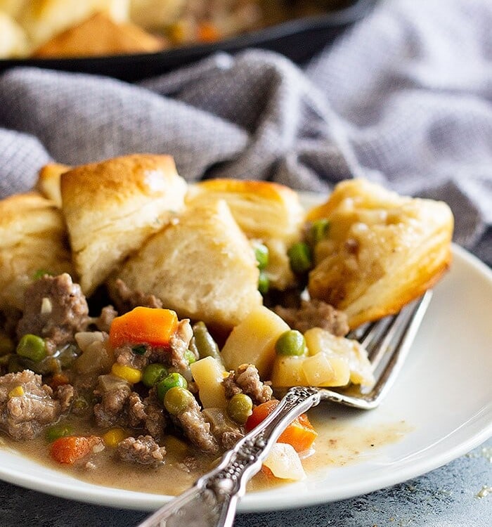 Easy skillet beef pot pie on a white plate with a fork