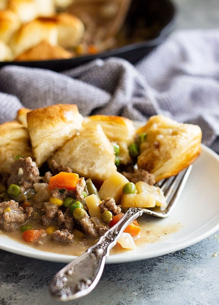 Easy skillet beef pot pie on a white plate with a fork