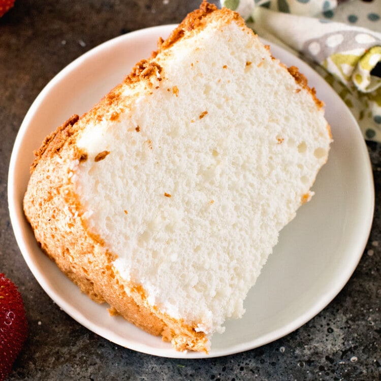 Slice of angel food cake on white plate