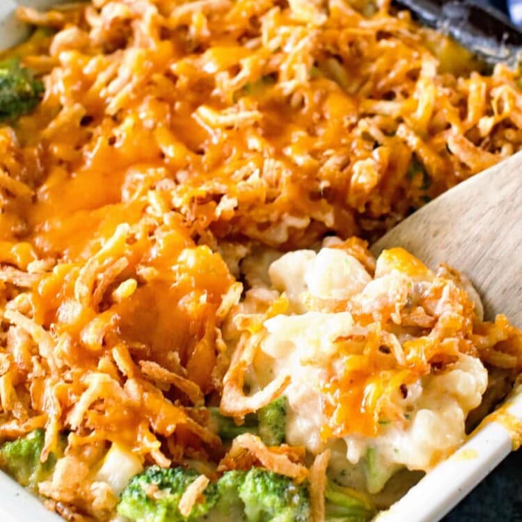 broccoli cauliflower cheese casserole with spoon in casserole dish