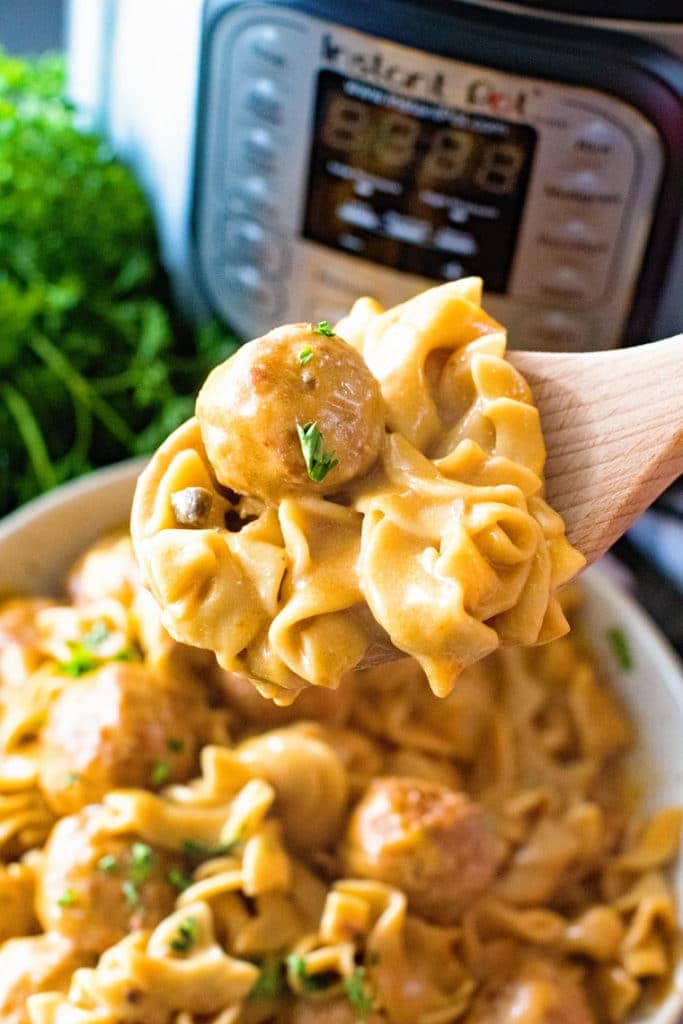 Spoon scooping swedish meatballs out of bowl