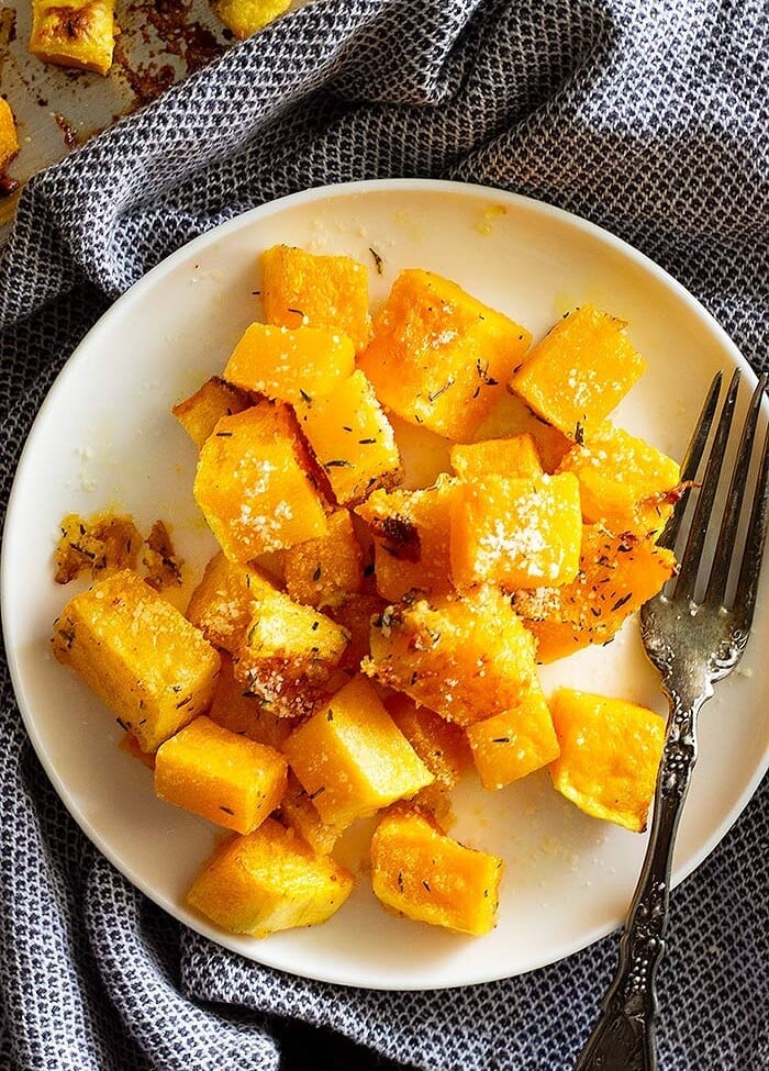 Parmesan roasted butternut squash chunks on a white plate