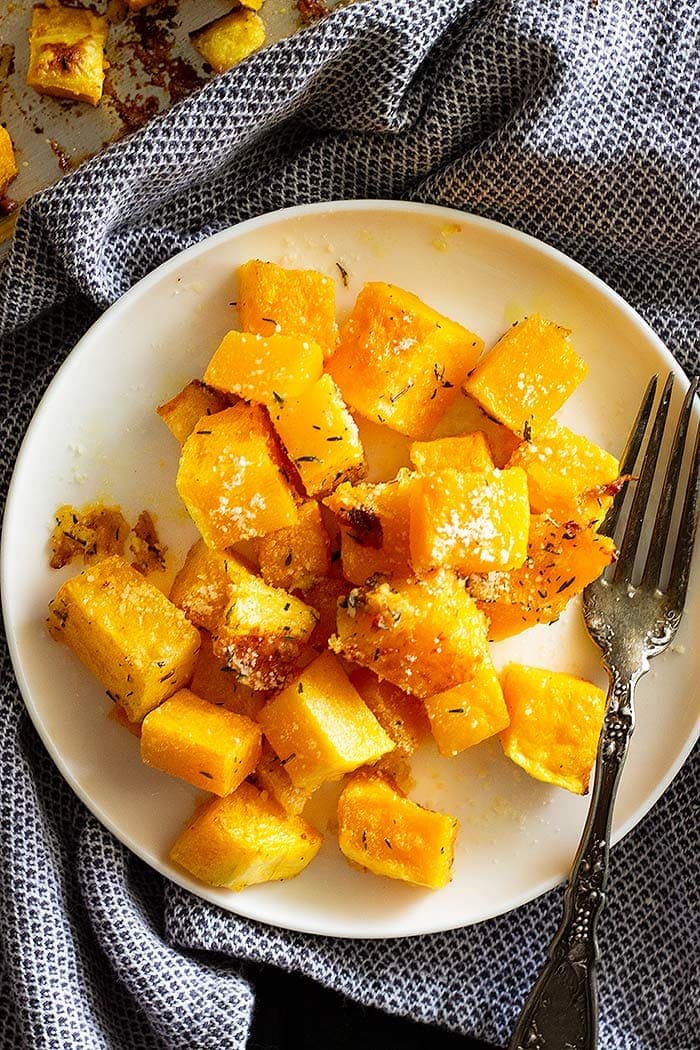 Butternut Squash Parmesan on a white plate with a fork.