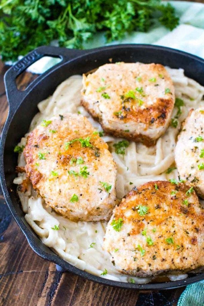 Baked pork chops in skillet with noodles