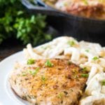 Oven baked pork chops on white plate