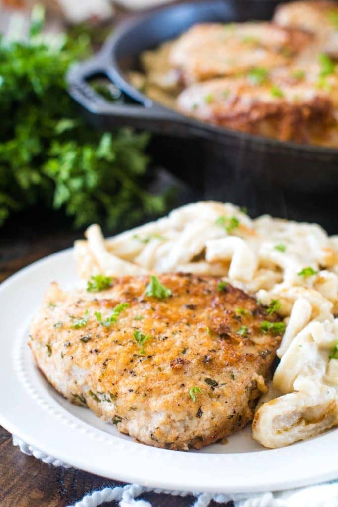 Oven baked pork chops on white plate