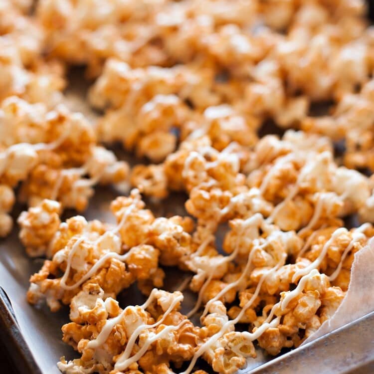 Butterscotch Popcorn drizzled with white chocolate on wax paper