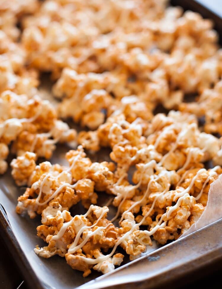 Butterscotch Popcorn drizzled with white chocolate on wax paper