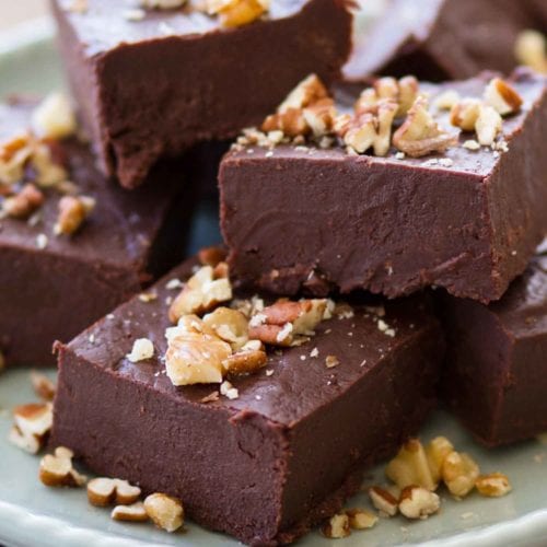 Chocolate fudge on plate with chopped nuts