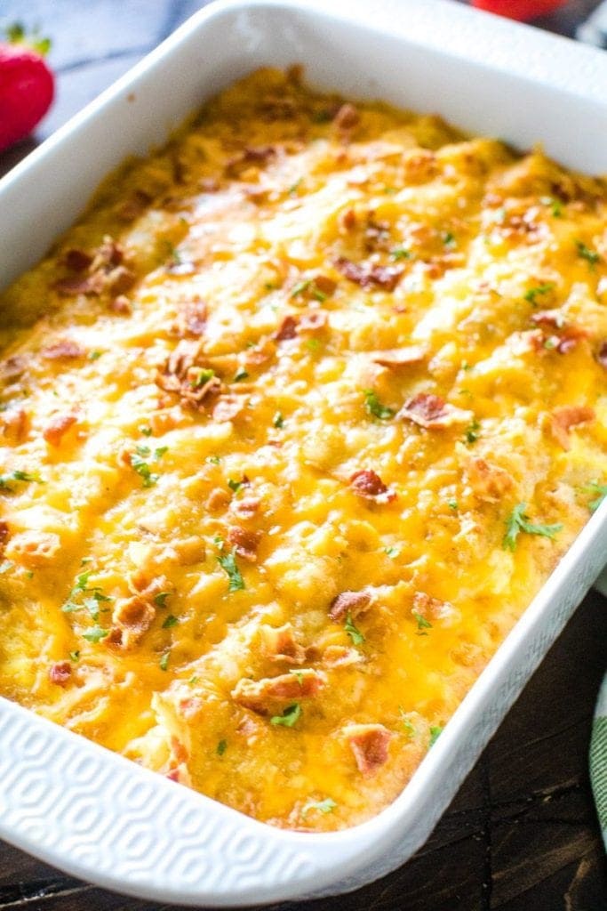 Tater Tot Sausage Breakfast Casserole Recipe in white casserole dish. The Breakfast Tater Tot Casserole is perfectly cooked with melted cheese and ready to serve.