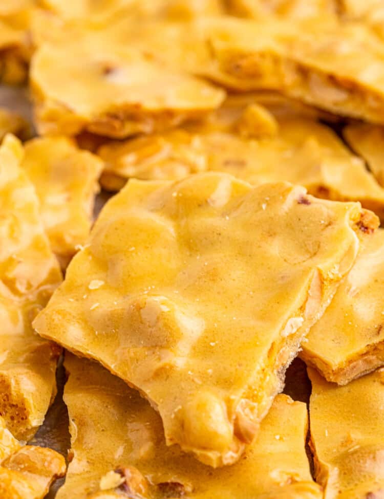 Microwave Peanut Brittle stacked on a pan