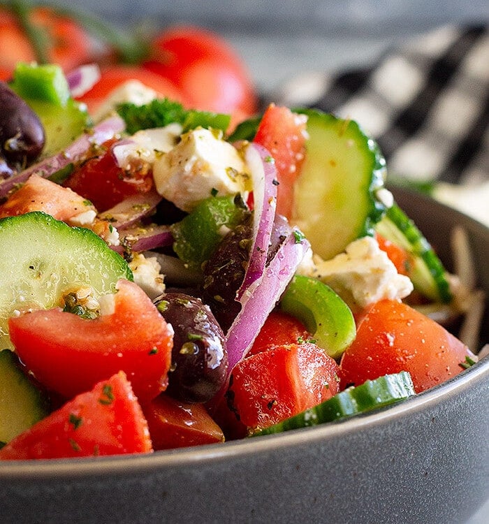 Chopped greek salad in a grey bowl