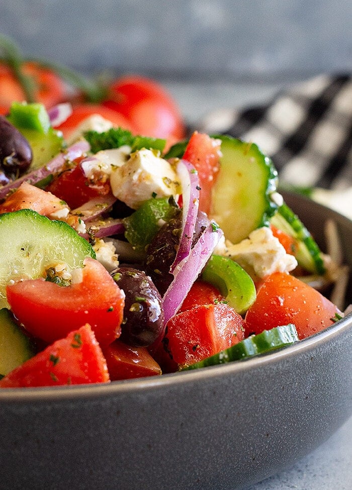 Chopped greek salad in a grey bowl