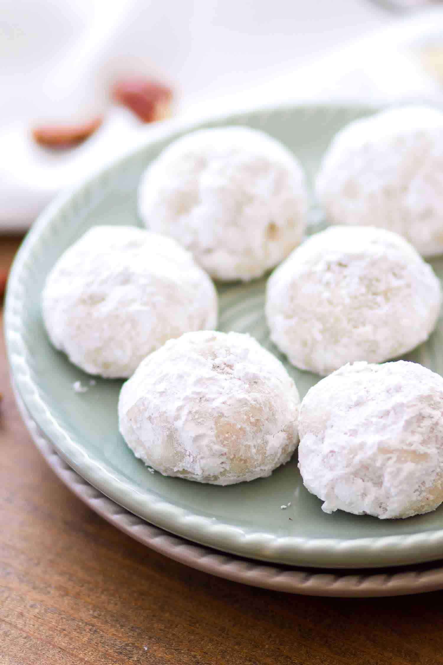 Mexican wedding cookies on a green plate