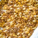 Chex Mix spread out on sheet pan