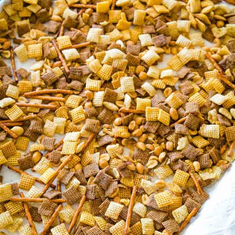 Chex Mix spread out on sheet pan