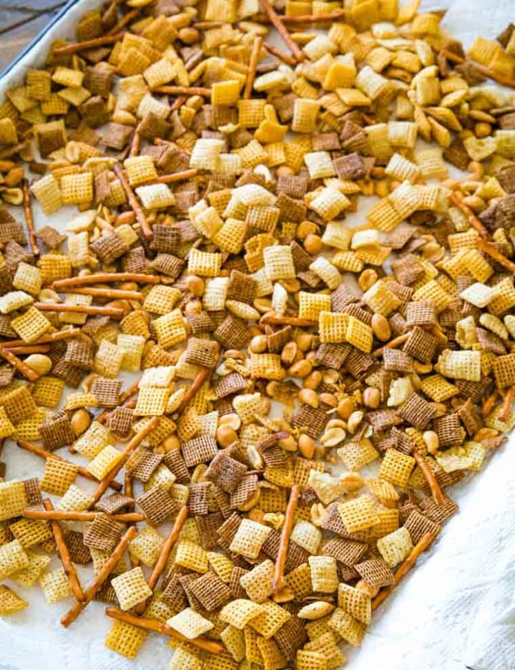 Chex Mix spread out on sheet pan