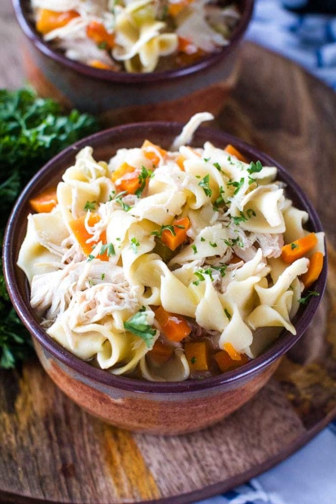 crockpot chicken noodle soup in brown bowl