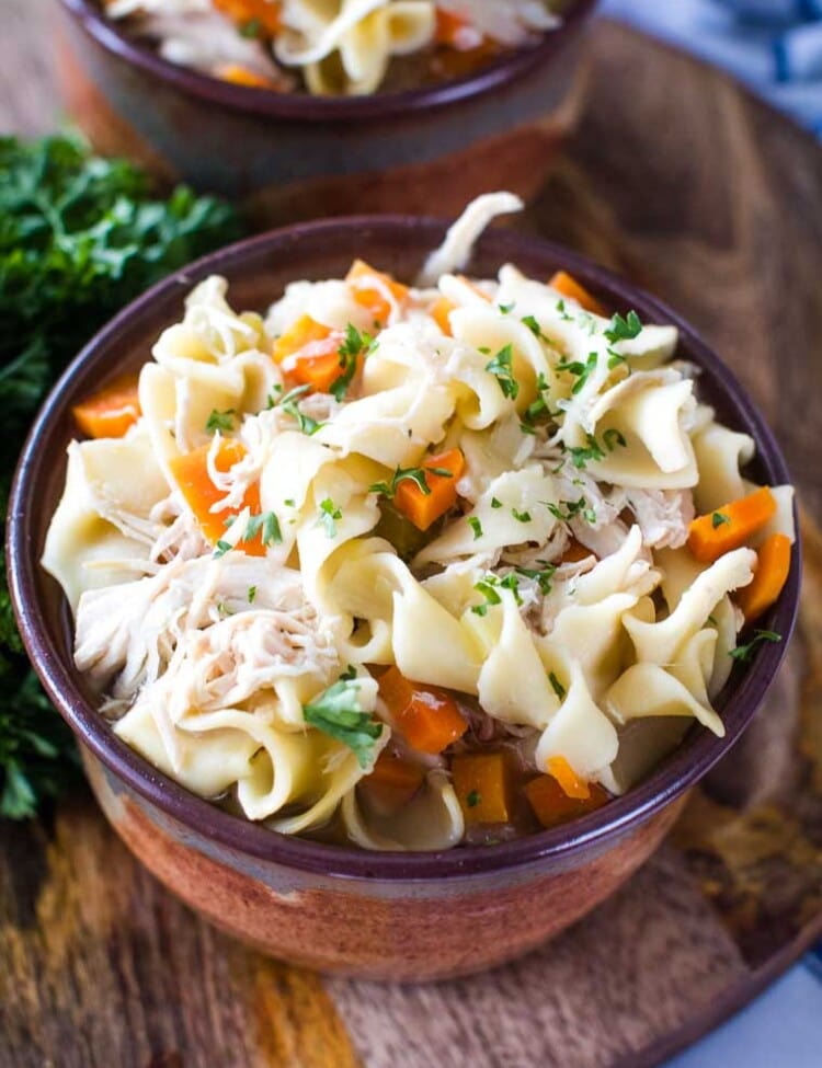 crockpot chicken noodle soup in brown bowl