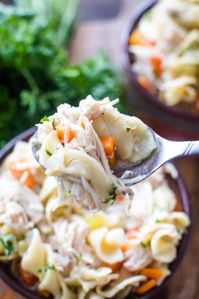 slow cooker chicken noodle soup on spoon