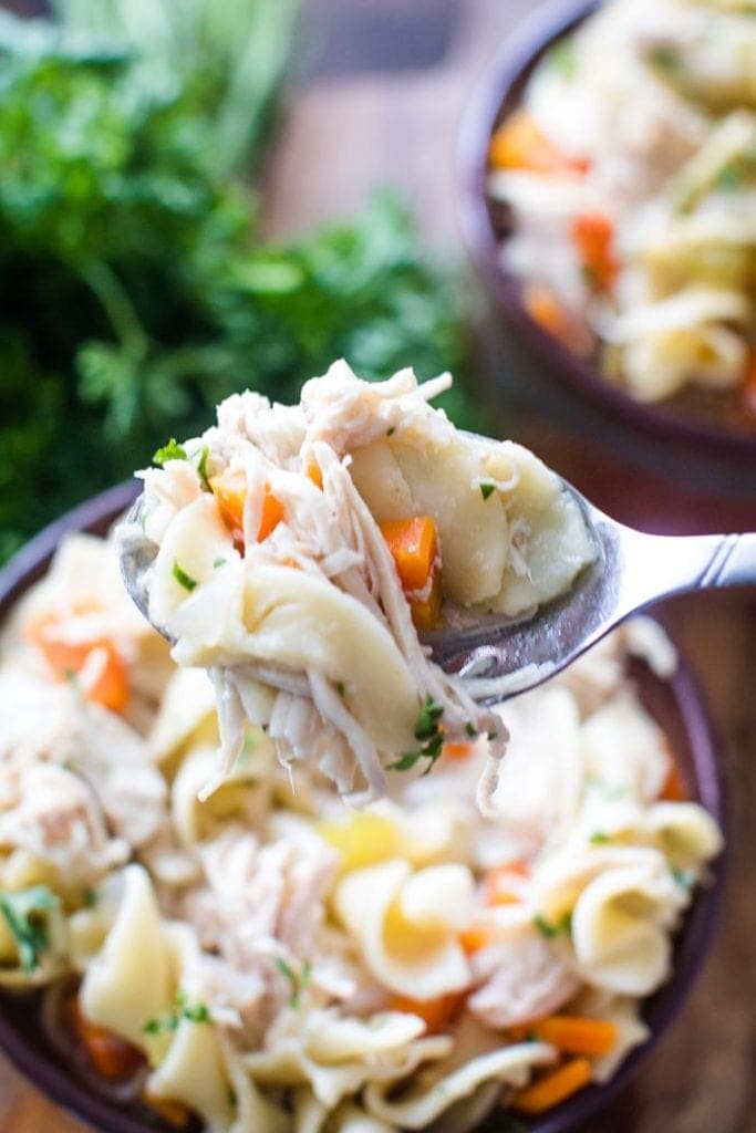 slow cooker chicken noodle soup on spoon