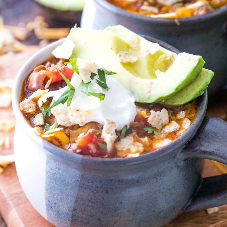 Taco Soup in bowl with sour cream and avocado