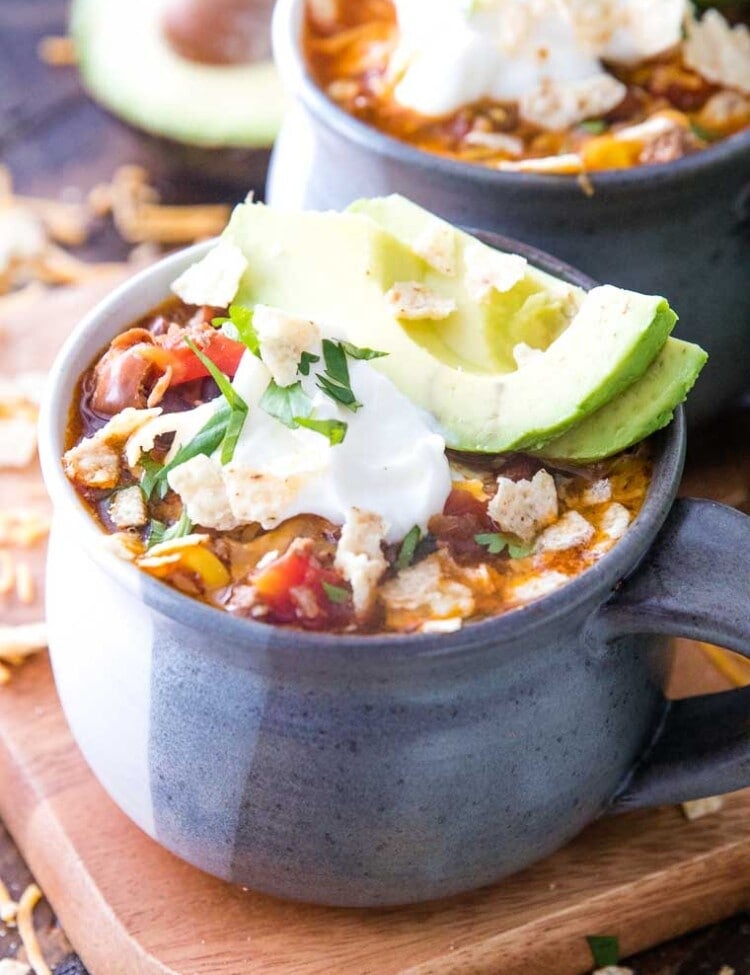 Taco Soup in bowl with sour cream and avocado