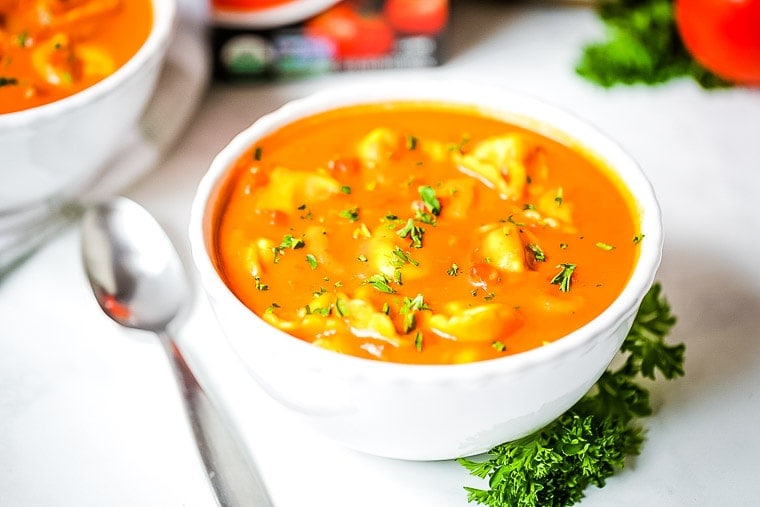 White bowl with tortellini tomato soup