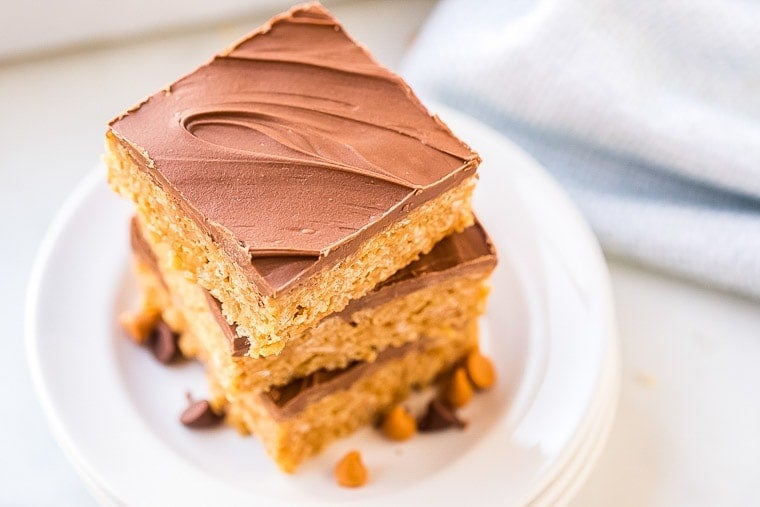 Chocolate Scotcheroos stacked on a white plate