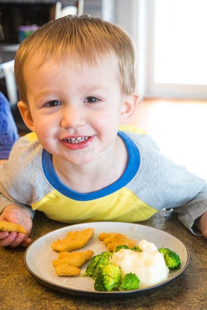 Child with dinner on plate