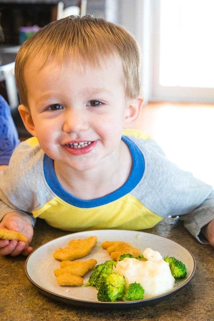 Child with dinner on plate