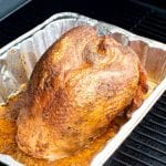 Turkey in a foil pan on the smoker