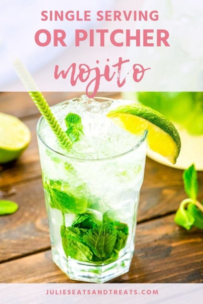 Mojito in a glass with mint, lime wedge, and a green straw